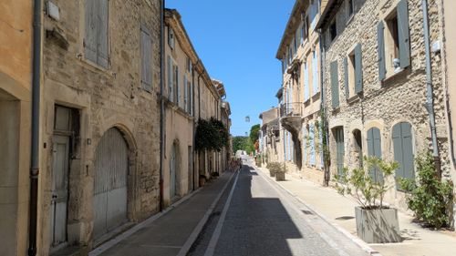 Free Explore a picturesque street in Grignan, Auvergne-Rhône-Alpes, France with historic architecture under clear skies. Stock Photo