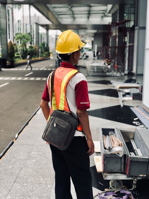 A Worker Wearing a Safety Hat and Vest