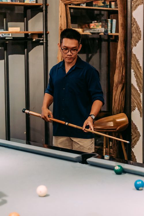Free Adult man playing billiards in a stylish Ho Chi Minh City bar setting. Stock Photo