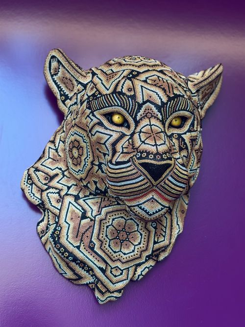 Free Artistic beaded jaguar sculpture against a vivid purple wall, showcasing intricate patterns. Stock Photo