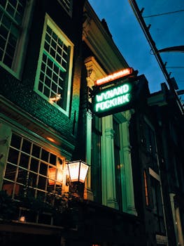 Neon lights illuminate Wynand Fockink's historic facade in Amsterdam's nightlife scene.