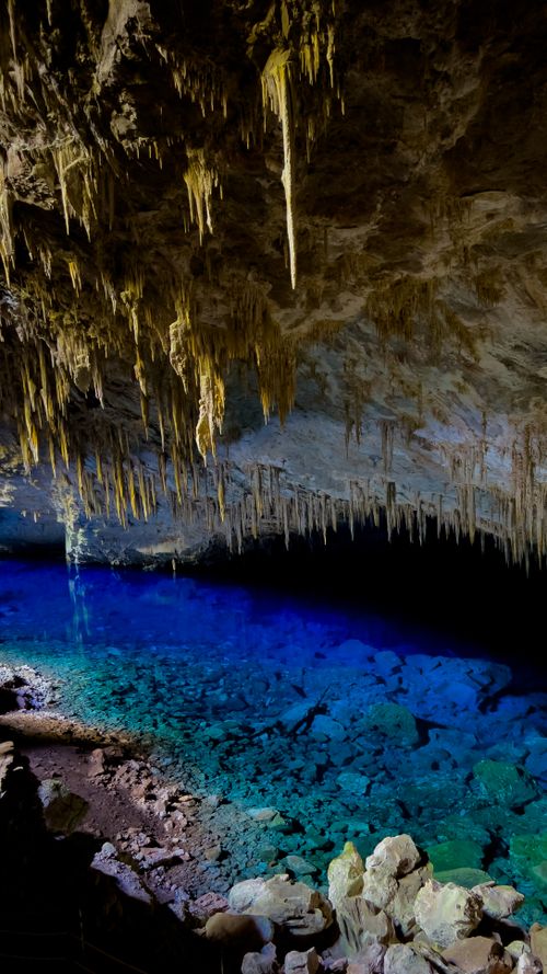 Free Stunning stalactites and vibrant blue lagoon in Gruta do Lago Azul Cave, Brazil. Stock Photo