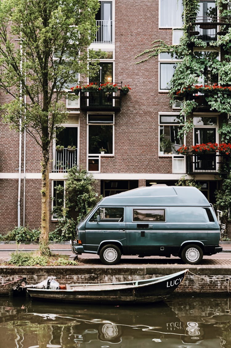 Van Parked In Front Of Brown Brick Building