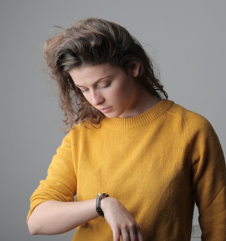 Woman In Yellow Sweater Wearing Brown Watch