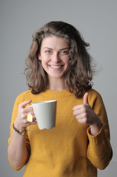 Free Woman in Yellow Sweater Holding White Ceramic Mug Stock Photo