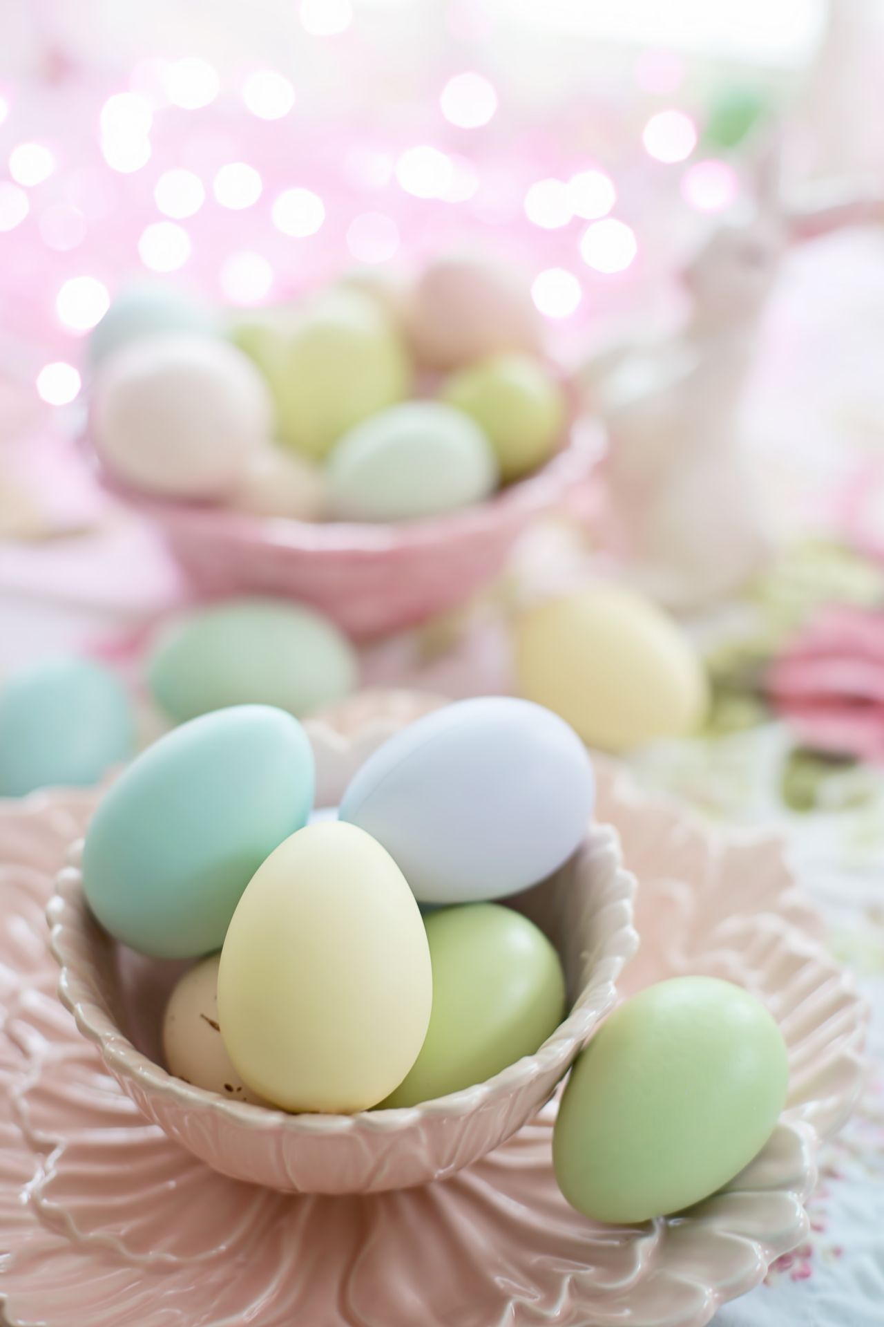 Vibrant pastel-colored Easter eggs nestled in beautiful ceramic bowls, perfect for spring celebration decor.