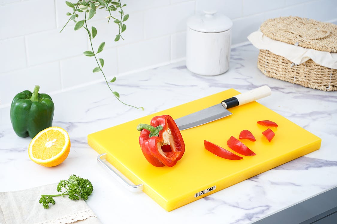 Free Red Bell Pepper On Yellow Chopping Board Stock Photo
