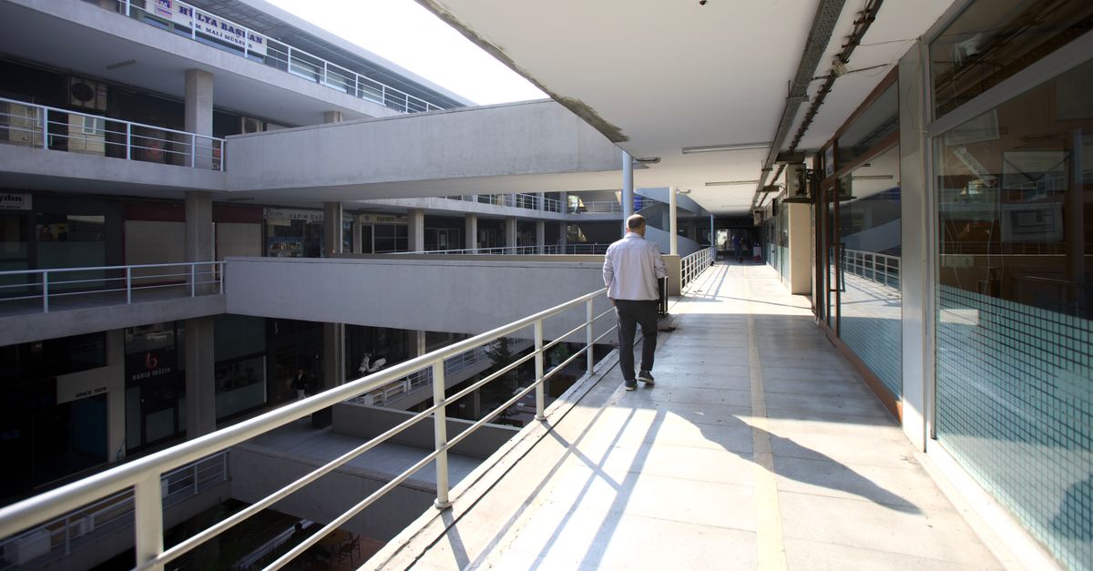 Man walking on a sunlit corridor in a modern office complex in Istanbul, Turkey.