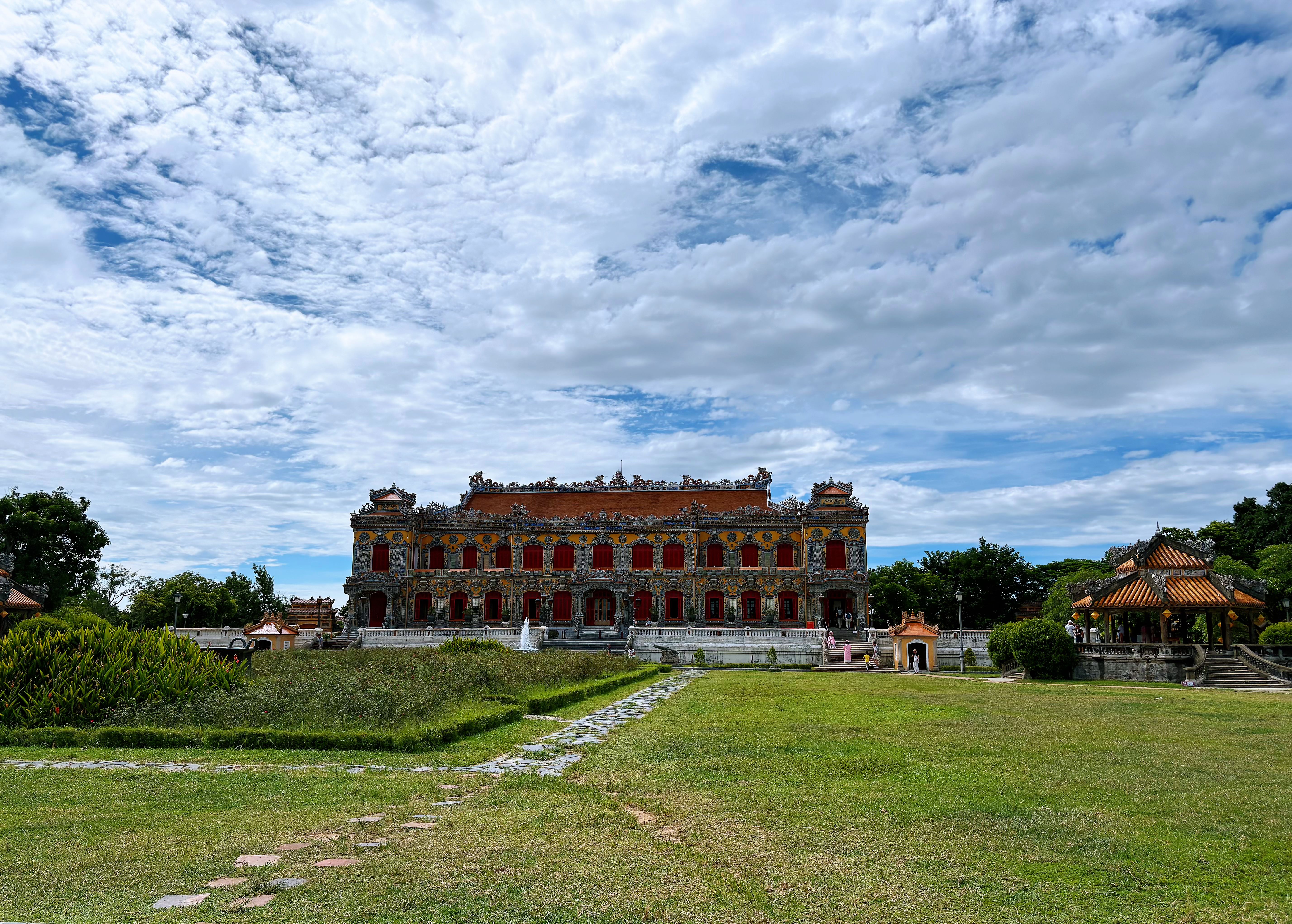 Scenic view of the Imperial City in Hue, Vietnam, showcasing historical architecture under a vibrant, cloudy sky. — lounges at Hue Airport