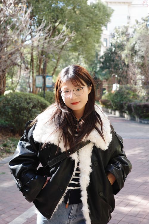 Free Casually dressed young woman with glasses enjoying a sunny day in Hefei, China. Stock Photo