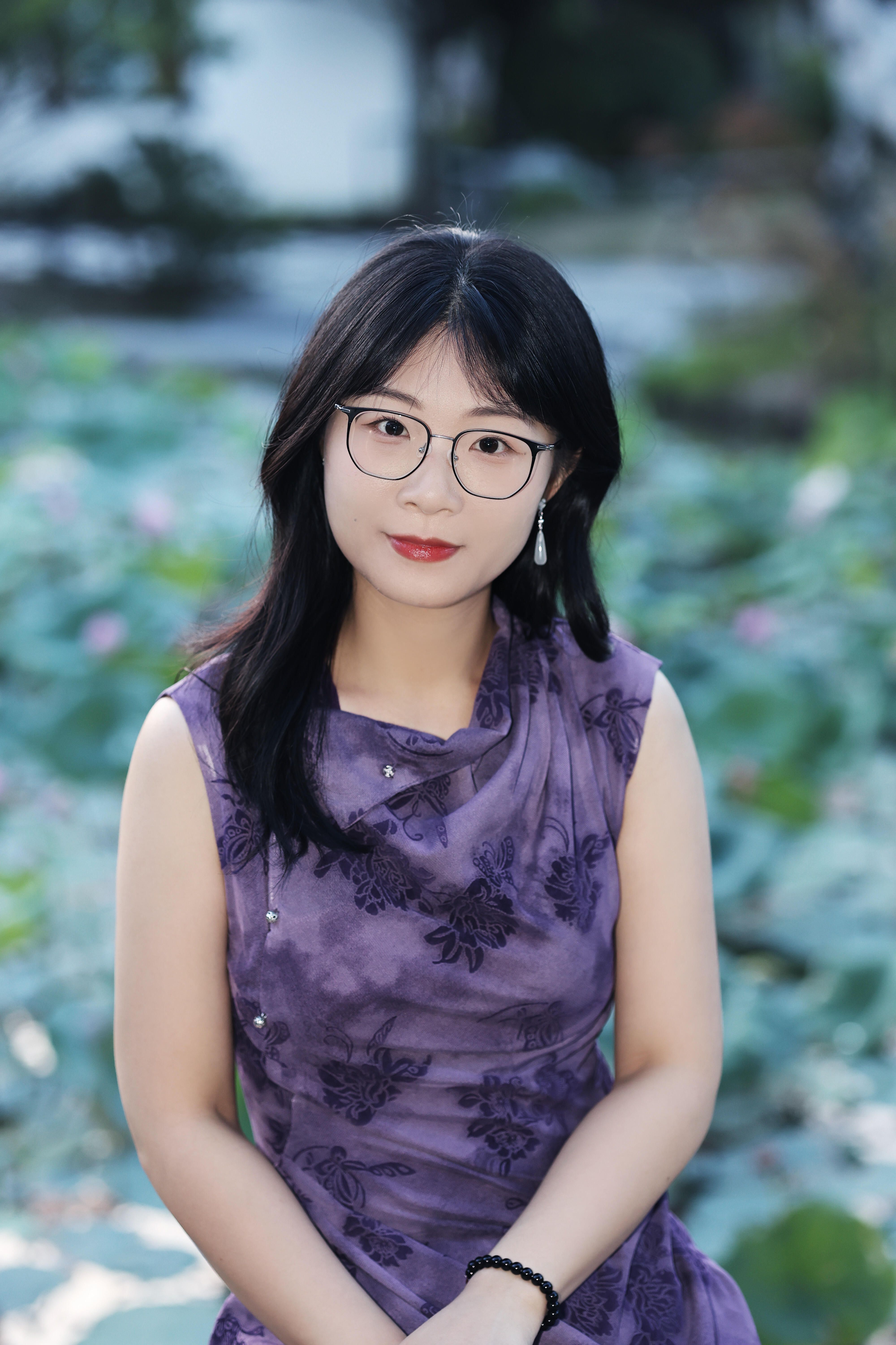 A serene portrait of an elegant woman in a purple dress sits amidst a lush lotus garden.