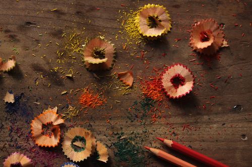 Free Vibrant pencil shavings and colorful debris on a rustic wooden surface. Stock Photo