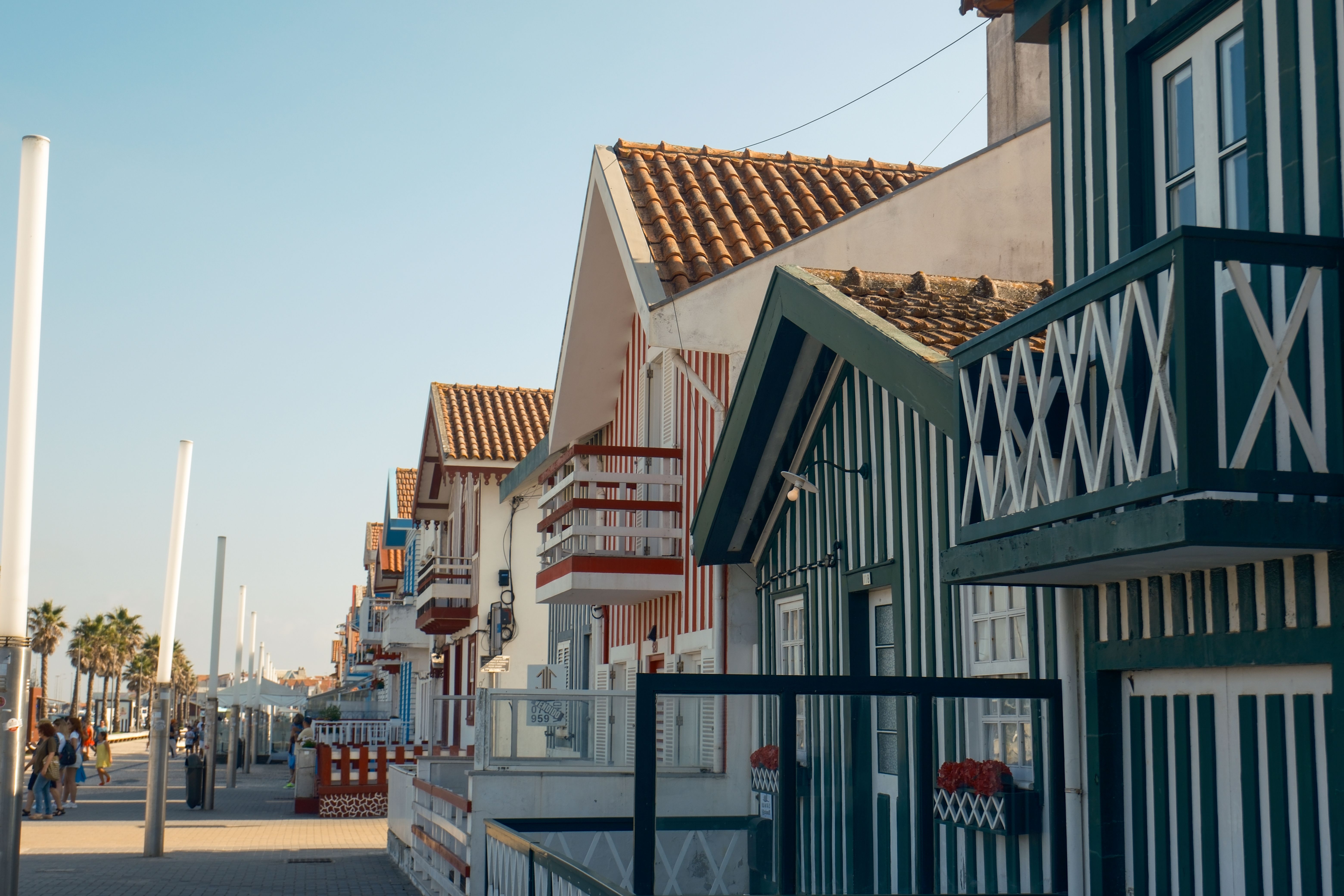 Quaint striped beach houses line the shore promenade in Costa Nova.