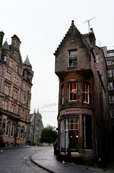 Historic buildings line a picturesque street in Edinburgh, Scotland, capturing timeless beauty.