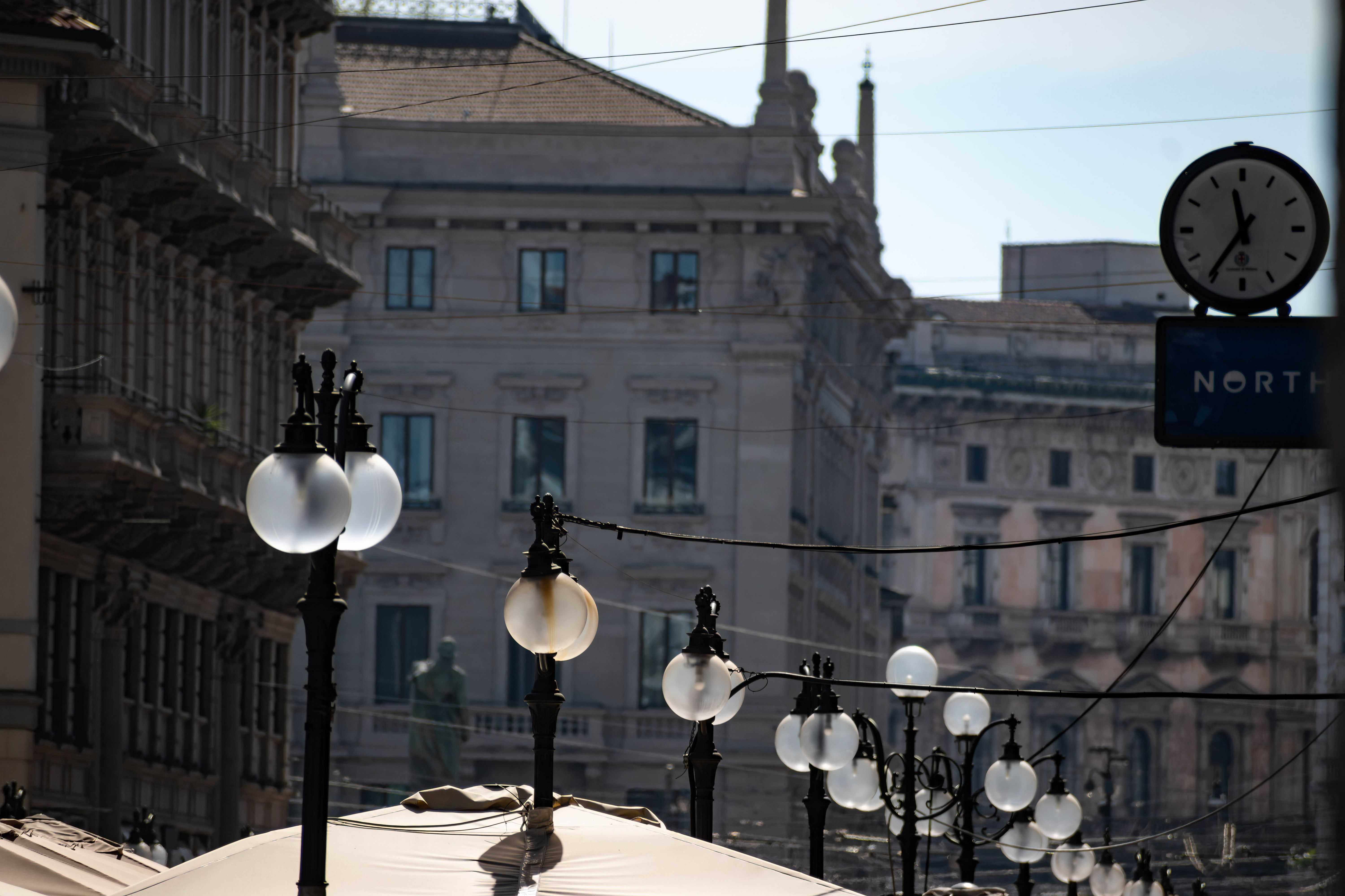 Historic architecture in Milan with decorative lamp posts lining elegant streets.