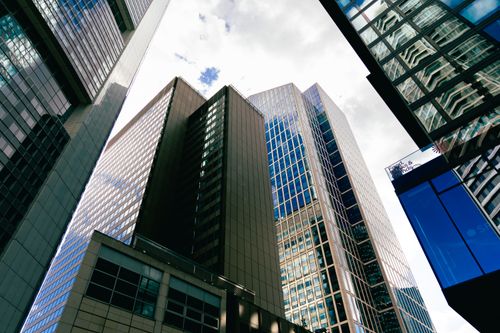 Free Tall skyscrapers in downtown Frankfurt am Main with a cloudy sky backdrop, showcasing modern architecture. Stock Photo