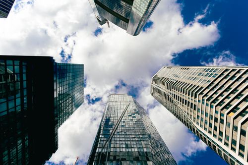 Free Upward view of Frankfurt skyscrapers reaching into a cloudy blue sky, showcasing modern architecture. Stock Photo