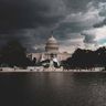 The US Capitol Building stands under dark, stormy clouds in Washington, D.C.
