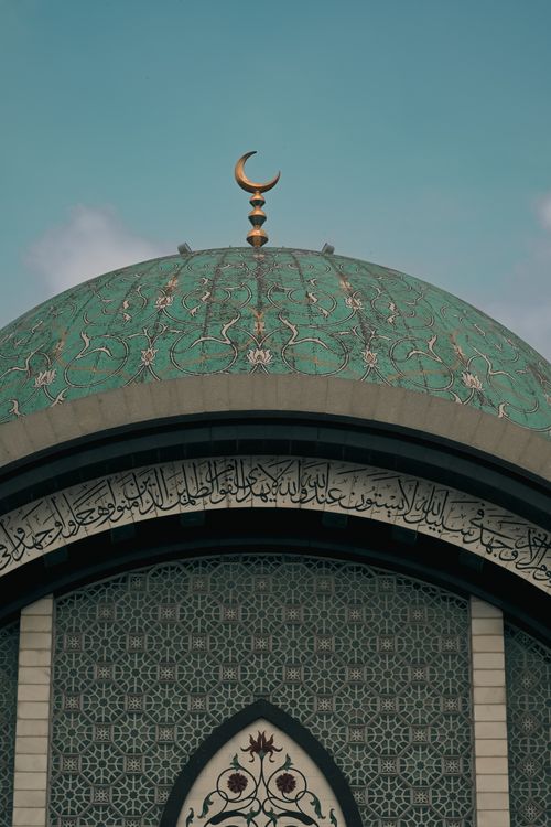 Free Intricate green dome with crescent symbol atop Islamic architecture in Kuala Lumpur. Stock Photo