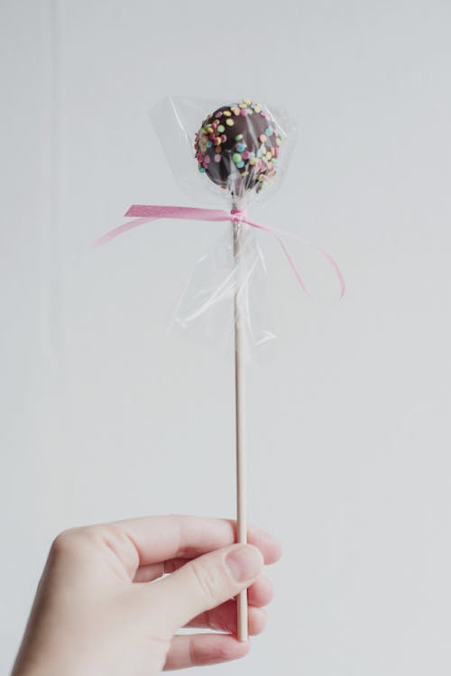 Free Person Holding Chocolate Lollipop  Stock Photo