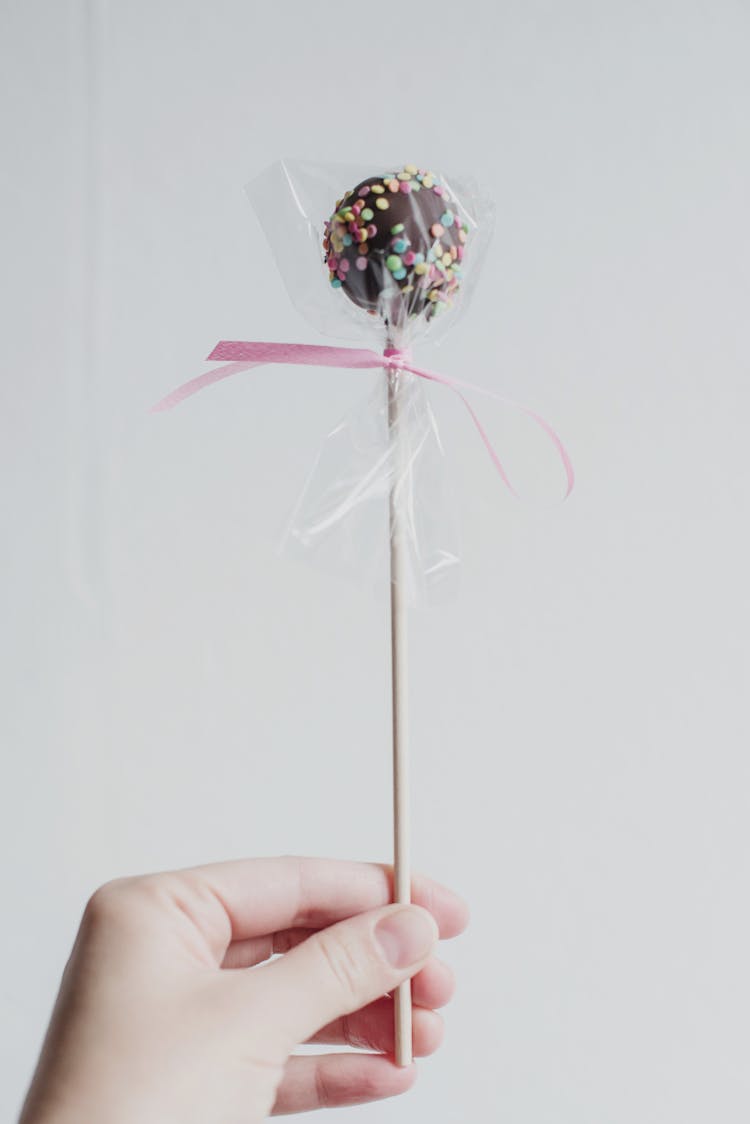 Person Holding Chocolate Lollipop 