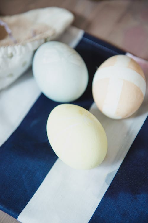 2 White Eggs on Blue Textile