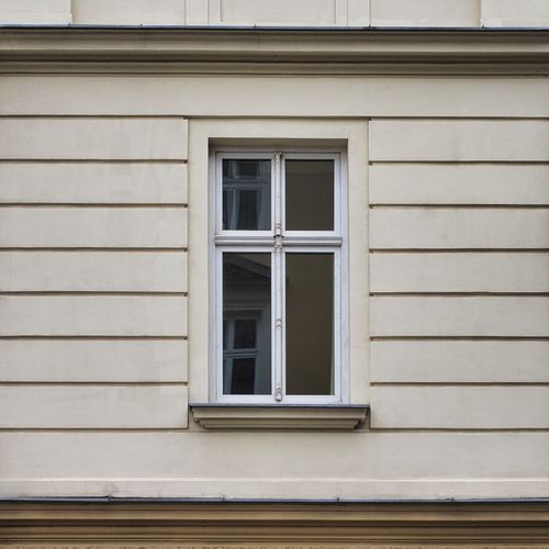Free Elegant cream-colored wall with a classic window in Warsaw, Poland. Stock Photo