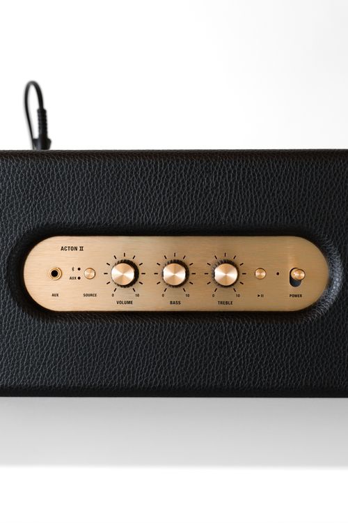 Free Close-up of a black speaker featuring a gold control panel with volume and bass knobs. Stock Photo