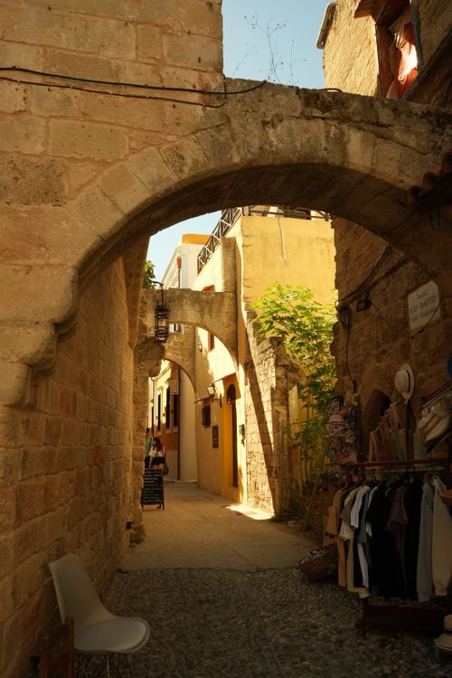 Free Explore a quaint medieval alleyway with stone arches and rustic charm in a historic European town. Stock Photo