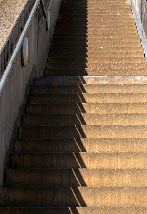 Free A concrete staircase outdoors with striking shadows creating an abstract pattern. Stock Photo
