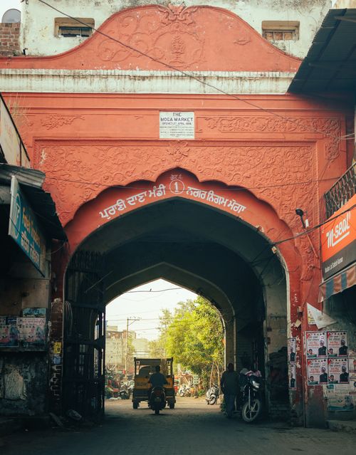 Free Classic red archway leading to Moga Market, showcasing local architecture in Punjab, India. Stock Photo