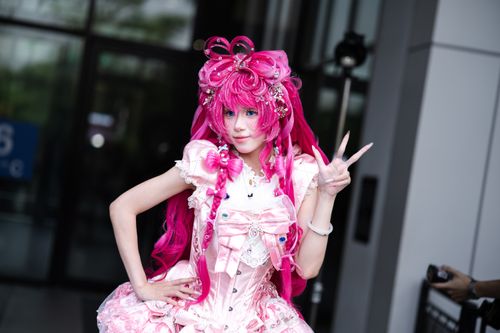 Free A vibrant cosplay character with elaborate pink hair and costume poses confidently outdoors. Stock Photo