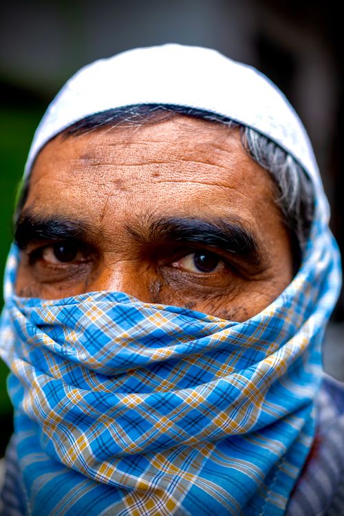 Free Portrait of a man with plaid turban covering his face, emphasizing his expressive eyes. Stock Photo