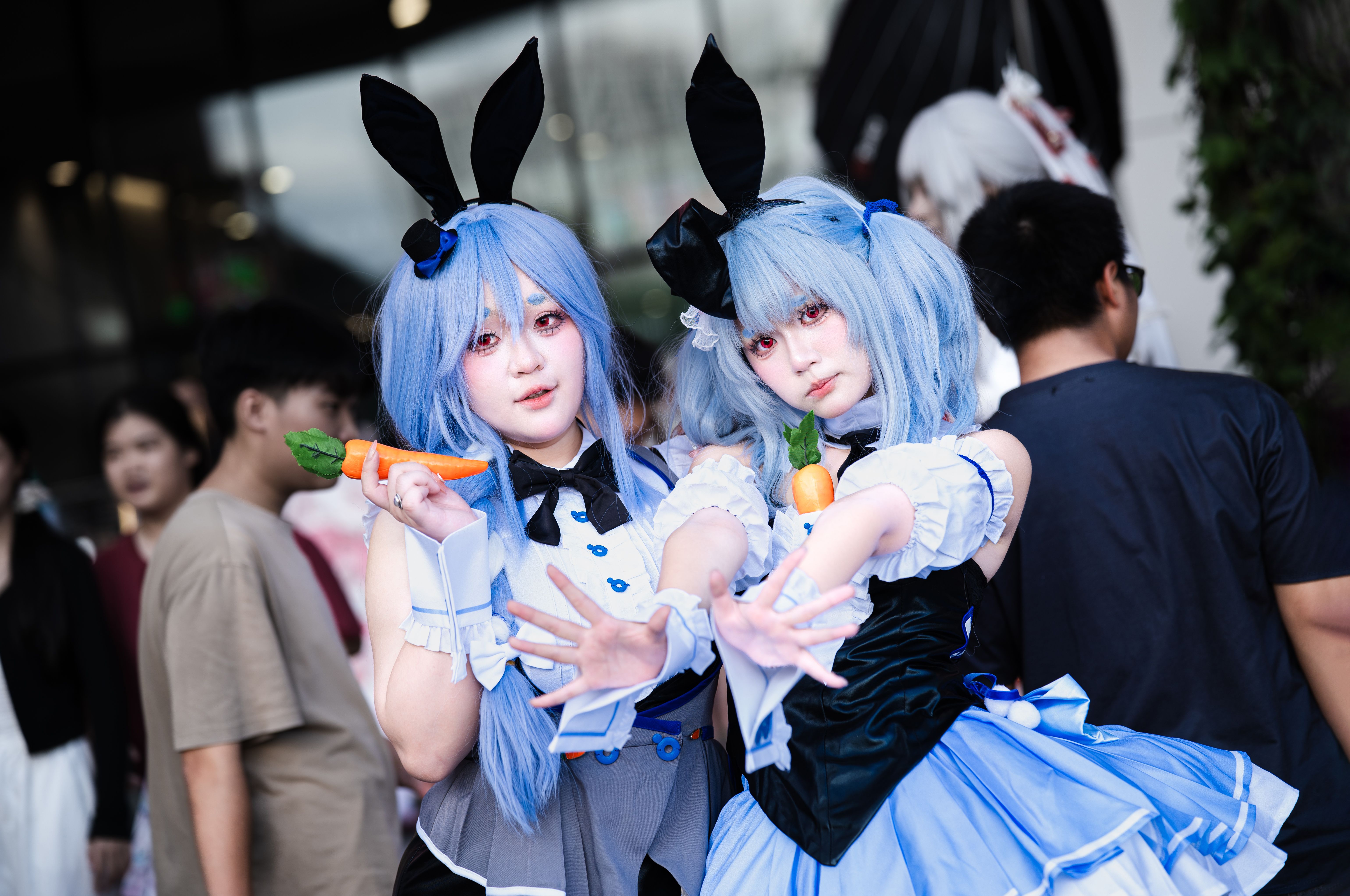 Vibrant cosplay event featuring anime characters with blue wigs and bunny ears.