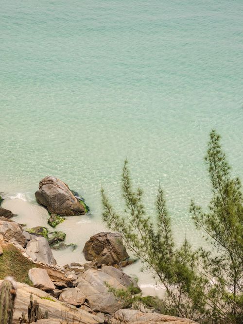 Free A serene coastal scene with turquoise waters and rocky shoreline in Brazil. Stock Photo