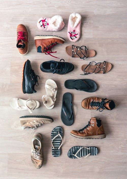 Assorted Shoes On Wooden Floor