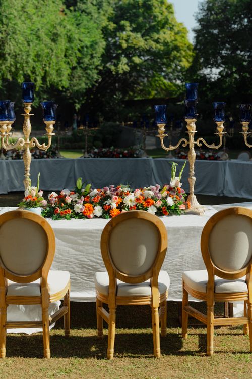 Free Beautifully decorated outdoor wedding table with floral arrangements and blue candle holders. Stock Photo