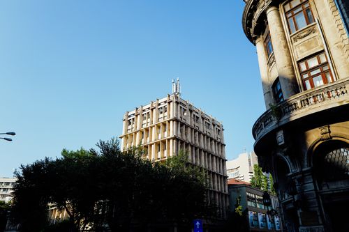 Free A view of historic architecture against a clear blue sky in an urban environment. Stock Photo