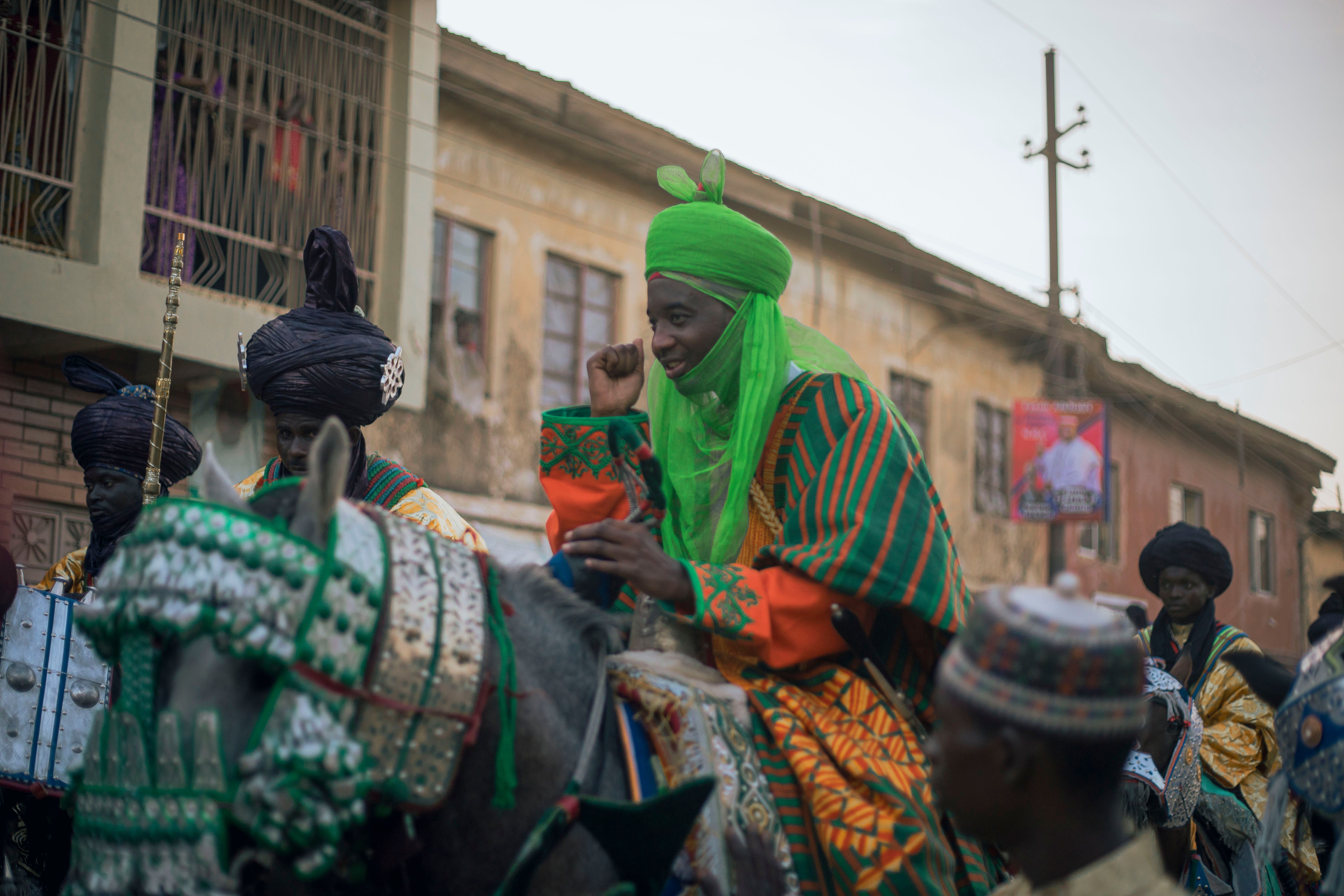 Colorful traditional parade showcasing vibrant attire and cultural heritage on horseback.