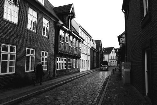 Free Black and white view of a cobblestone street in historic Lüneburg, Germany. Stock Photo