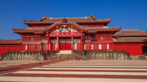 Free Beautiful view of Shuri Castle in Okinawa, Japan, showcasing traditional architecture under a clear blue sky. Stock Photo