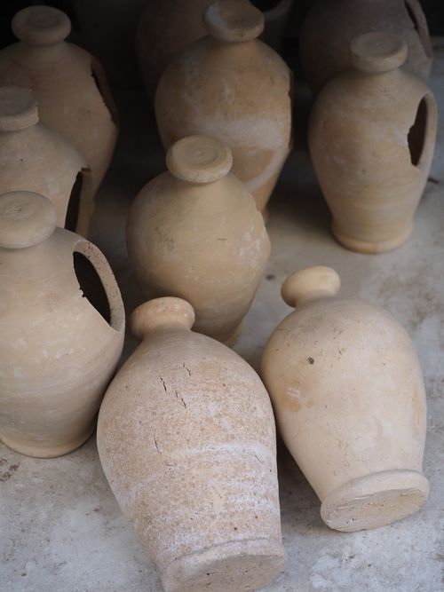 Free Collection of traditional ceramic vases displayed at a street market in Doha, Qatar. Stock Photo