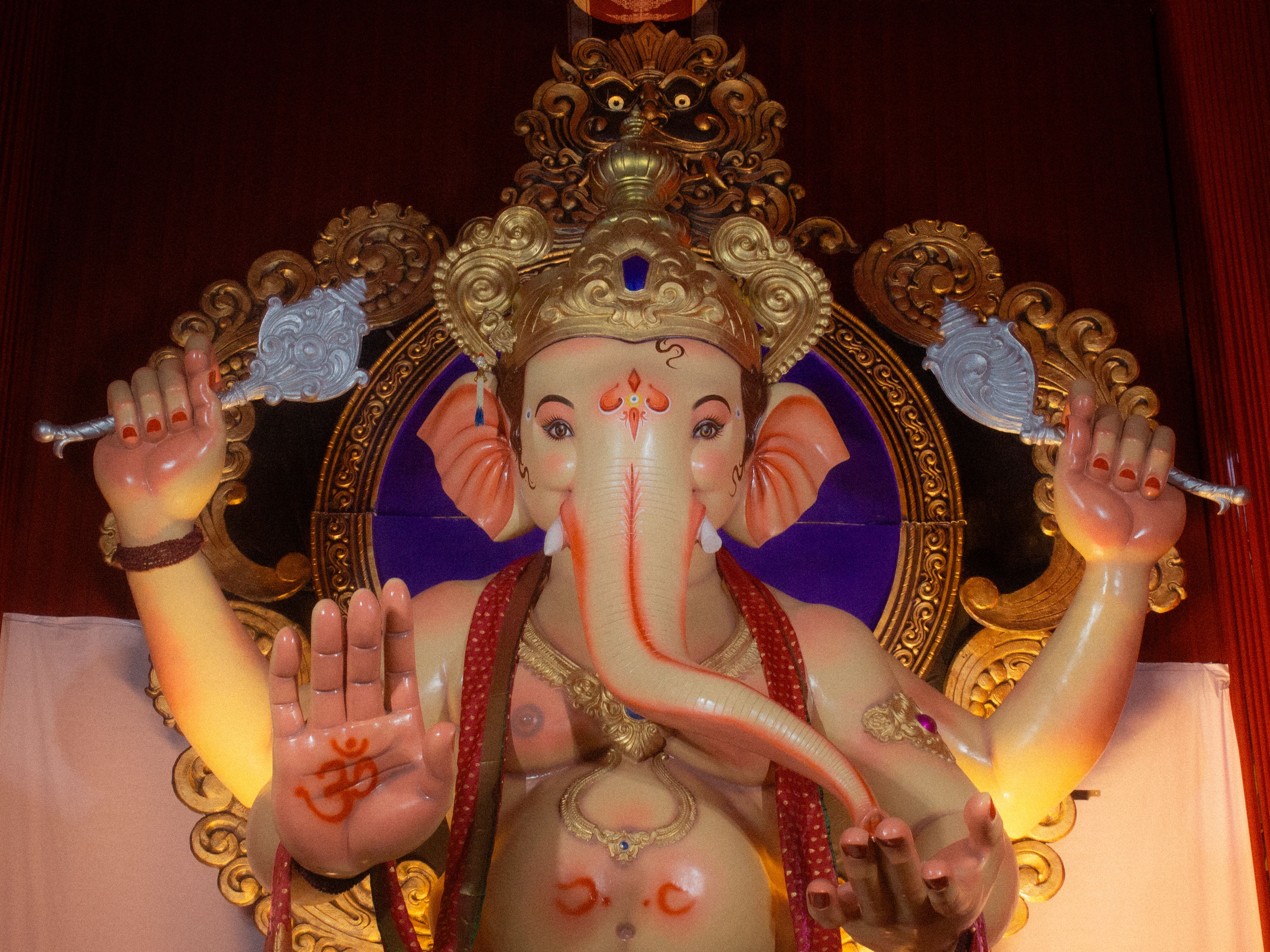 Detailed image of a Ganesha idol with vibrant decorations in Nashik, India.