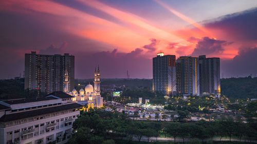 Free A breathtaking sunset casts vibrant colors over a mosque and cityscape in West Java, Indonesia. Stock Photo