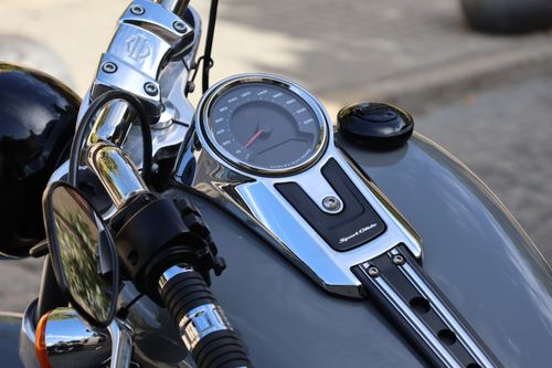 Free Detailed view of a motorcycle's dashboard highlighting the speedometer, handlebars, and chrome details under the bright Andalusian sun. Stock Photo