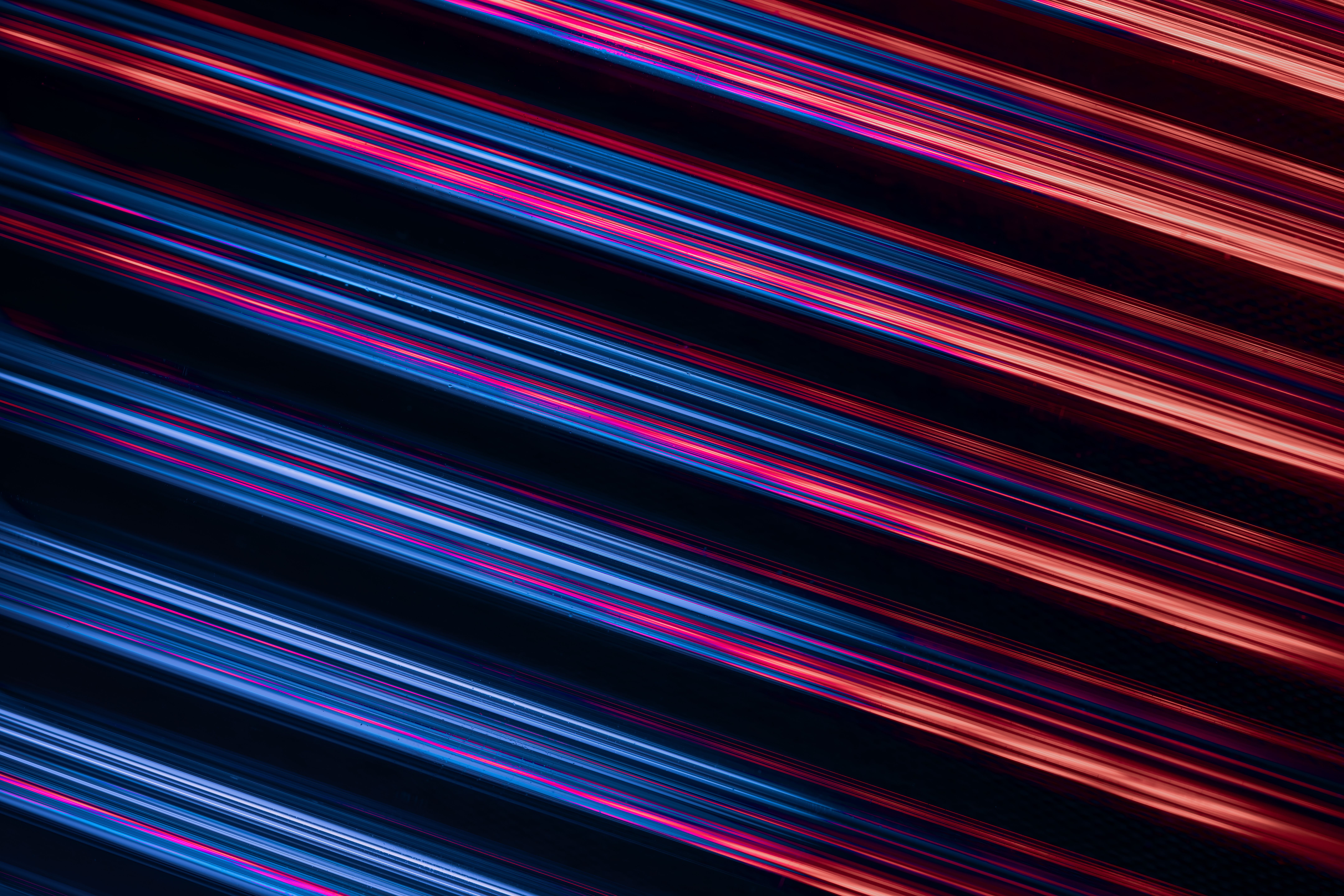 Vivid abstract design with neon blue and red light trails creating an energetic visual impact.