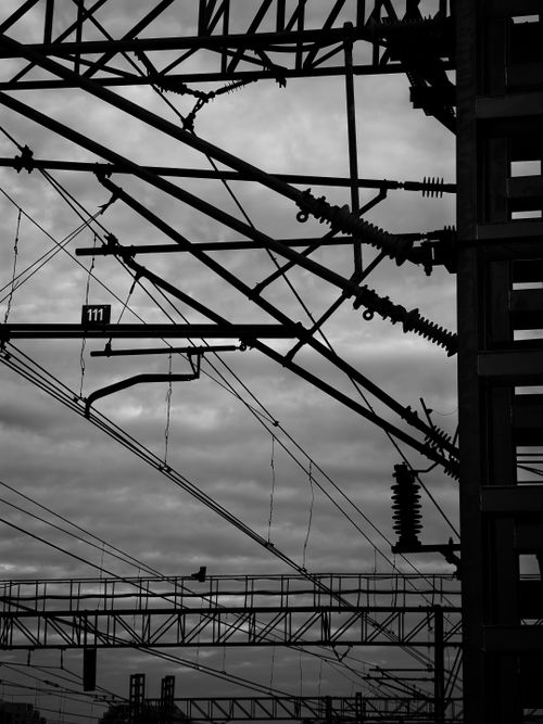 Free Abstract view of industrial power lines in silhouette against cloudy sky. Stock Photo