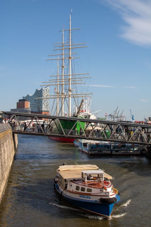 Free A vibrant scene of the Elbe River in Hamburg featuring a sailing ship and the Elbphilharmonie. Stock Photo