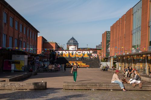 Free A lively urban area in Hamburg with people enjoying the day under a clear blue sky. Stock Photo