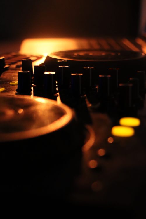 Free Close-up of DJ controller in warm, ambient lighting, capturing an artistic, moody vibe. Stock Photo